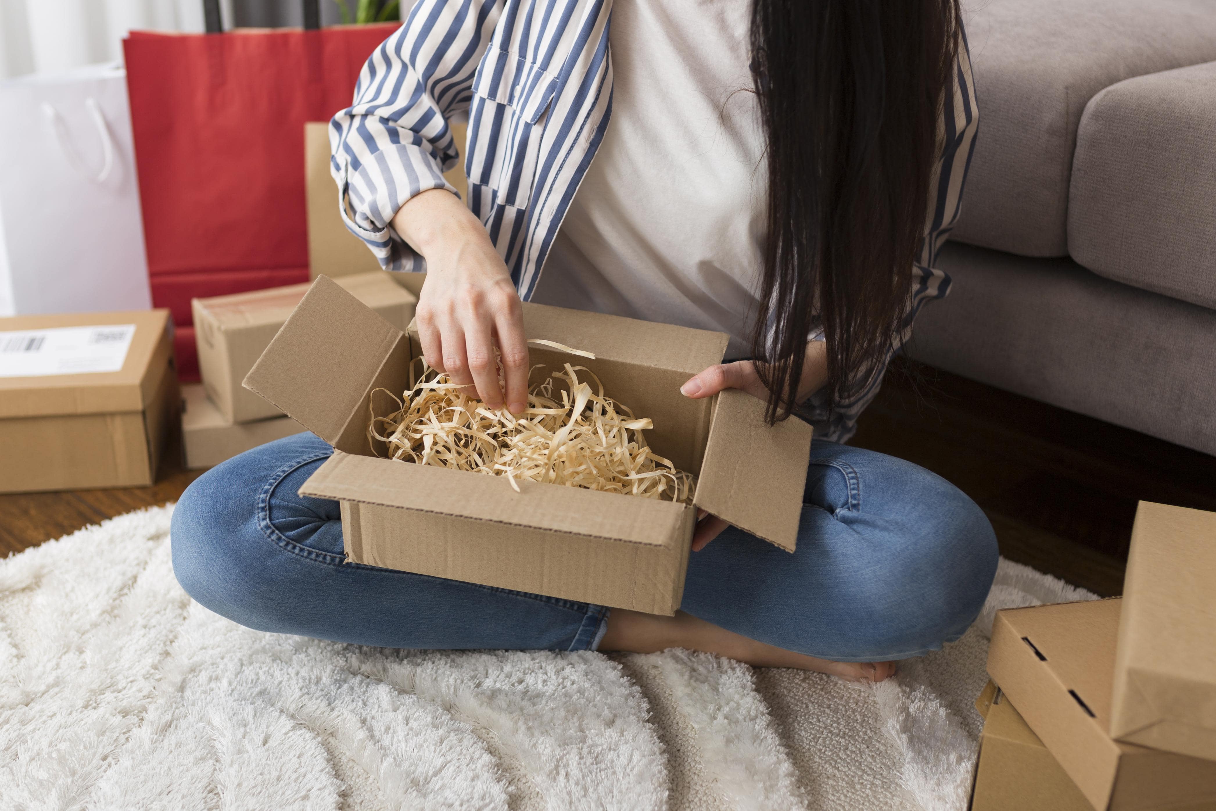 high-angle-woman-unboxing-min